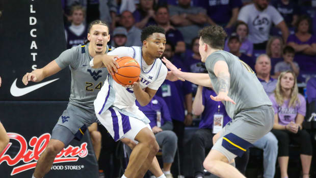 Feb 26, 2024; Manhattan, Kansas, USA; Kansas State Wildcats guard Tylor Perry (2) is dribbles as West Virginia Mountaineers forwards Patrick Suemnick (24) and Quinn Slazinski (11) defend during overtime at Bramlage Coliseum. Mandatory Credit: Scott Sewell-USA TODAY Sports